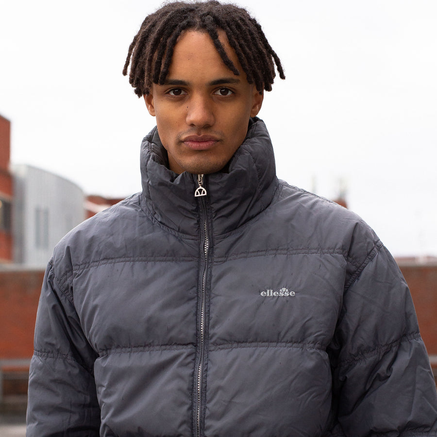 Ellesse 90's Embroidered Spellout Down Puffer Jacket in a Dark Grey